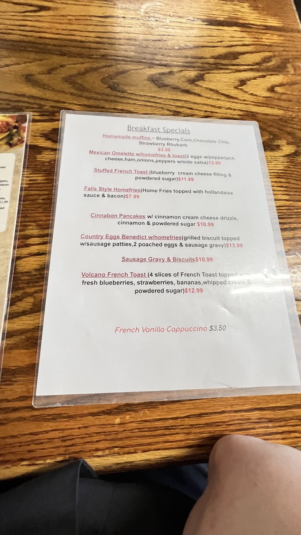 Printed menu beside coffee and dessert options.